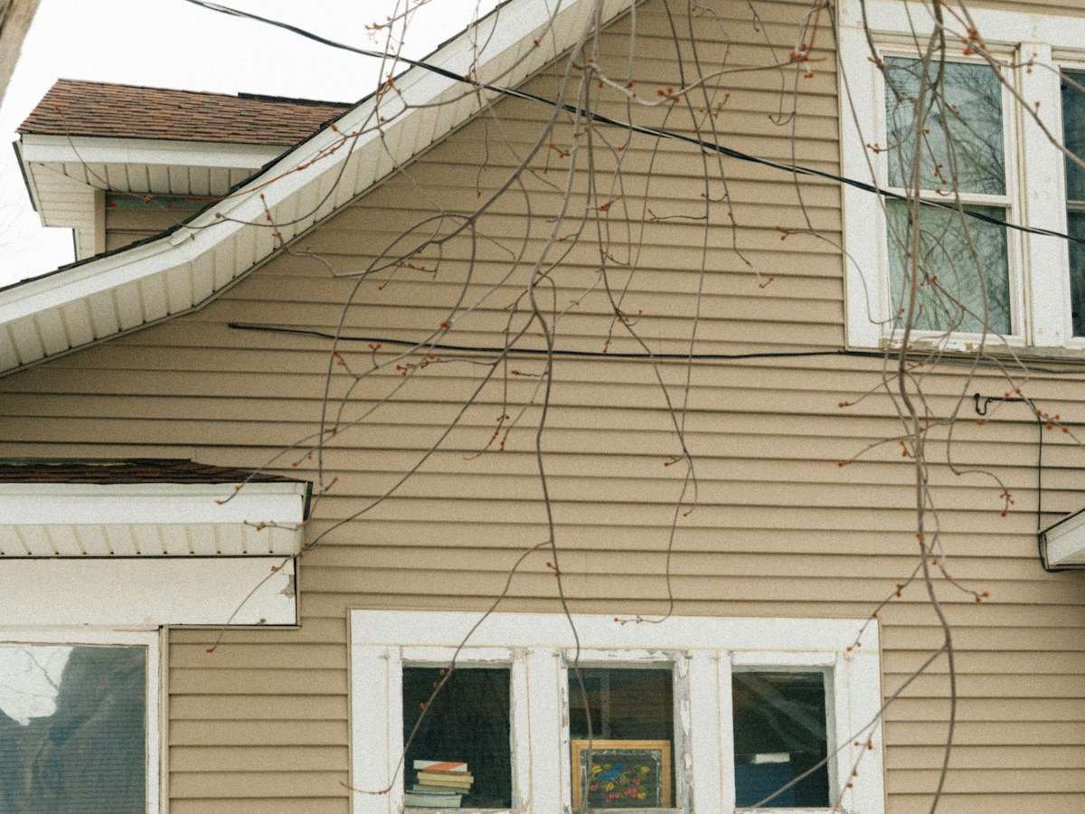 House exterior with a ladder, ready for paint