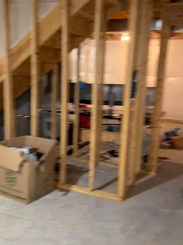 Basement with new wood stud walls framed around a room